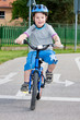 Baby boy on traffic playground for childs with crash helmet