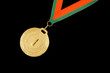 Gold medal with ribbon isolated on black