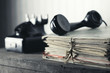 Foto: Old phone on a desk with documents Old phone on a desk with documents