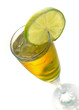 Yellow cocktail in glass with lime