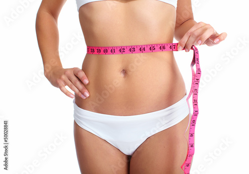 Photo: Young woman with a measuring tape. Young woman with a measuring tape.