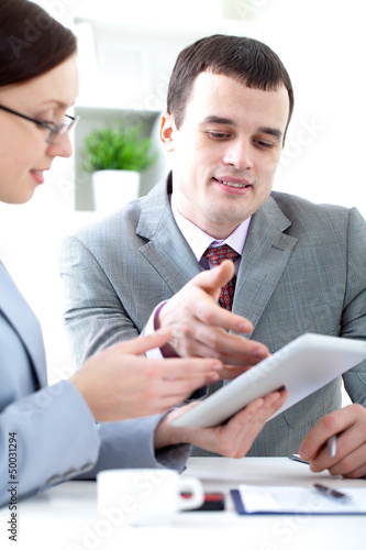 Photo: Business people working with digital tablet Business people working with digital tablet