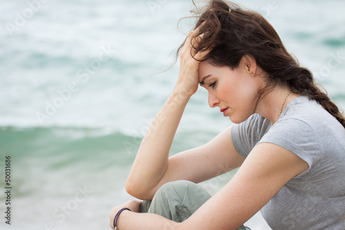 Photo: Sad and upset woman deep in thought Sad and upset woman deep in thought