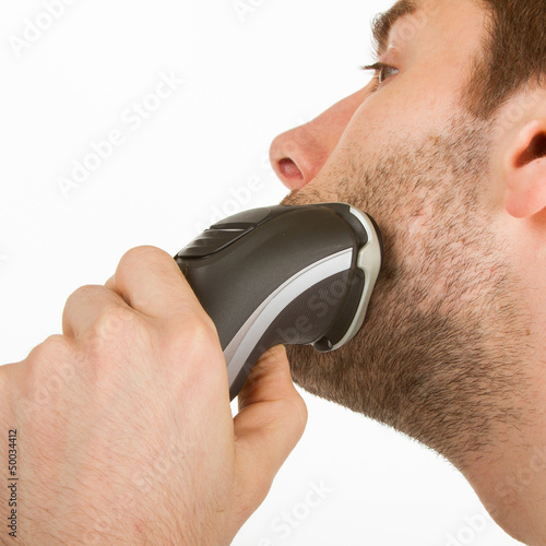 Photo: Young man shaving his beard off Young man shaving his beard off