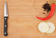 Knife, onion and pepper on cutting board