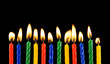 Burning candles on black background