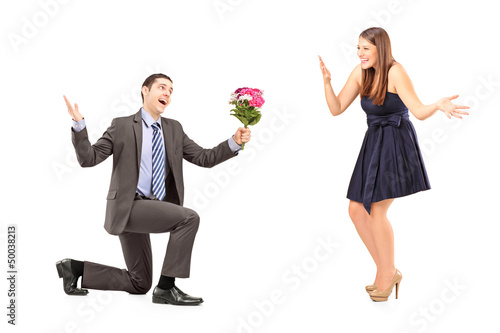 Photo: Young romantic man giving a bouquet of flowers to a woman Young romantic man giving a bouquet of flowers to a woman