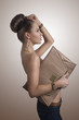 fashion brunette in jeans with big bag in profile