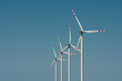 Photo: Wind turbine farm on blue sky background Wind turbine farm on blue sky background