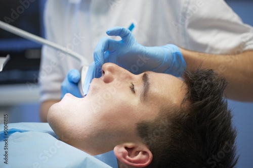Photo: Young man in dentist office Young man in dentist office