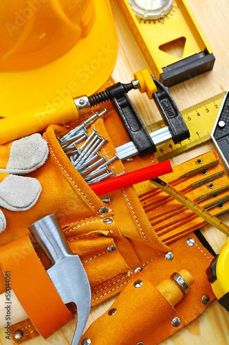 Photo: building tools in belt and hardhat building tools in belt and hardhat