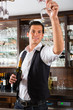 Barman standing behind bar with wine
