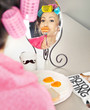 Woman with sausages on a fork simulating lip enhancement