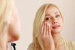 Photo: Woman caring of her beautiful skin on the face Woman caring of her beautiful skin on the face