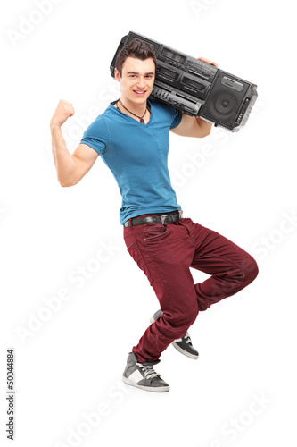 Photo: Full length portrait of a young muscular man posing with a radio Full length portrait of a young muscular man posing with a radio