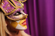 woman in violet carnival mask