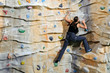 Photo: woman on rock wall in sport centre woman on rock wall in sport centre
