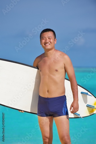 Photo: Man with surf board on beach Man with surf board on beach