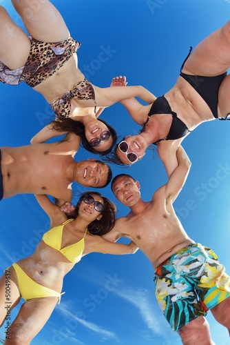 Photo: group of happy young people have fun on bach group of happy young people have fun on bach