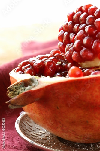Photo: pomegranate ripe fruit on a silver plate pomegranate ripe fruit on a silver plate