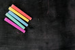 Row of color chalk on a blackboard