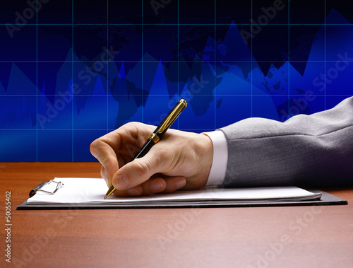 Photo: businessman's hand with pen businessman's hand with pen