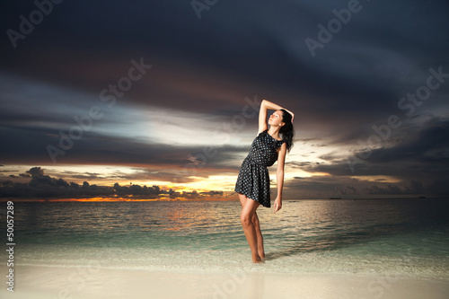 Photo: Fashion woman on the sea sunset background Fashion woman on the sea sunset background