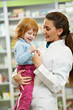 Pharmacy chemist with child in drugstore