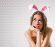 Woman with bunny ears thinking