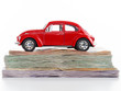 Red car on top of stacked money