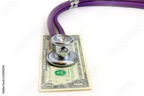 Photo: stethoscope doctor and dollars as illustration pay medicine stethoscope doctor and dollars as illustration pay medicine