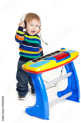 Photo: little boy and the keyboard on white background. funny boy baby. little boy and the keyboard on white background. funny boy baby.