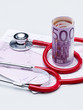 Stethoscope and money on doctor's prescription