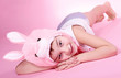 Foto: Cute smiling boy dressed as rabbit, pink background. Cute smiling boy dressed as rabbit, pink background.