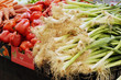 green onions and peppers on market stand