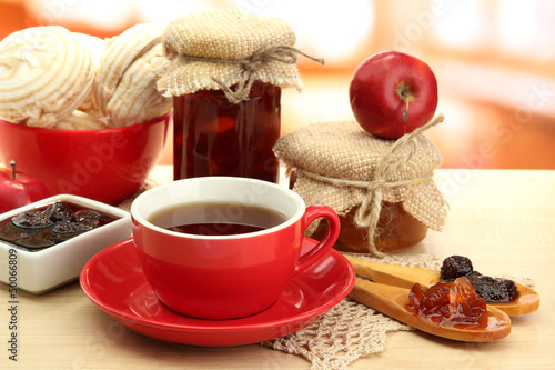 Photo: light breakfast with tea and homemade jam, on wooden table light breakfast with tea and homemade jam, on wooden table