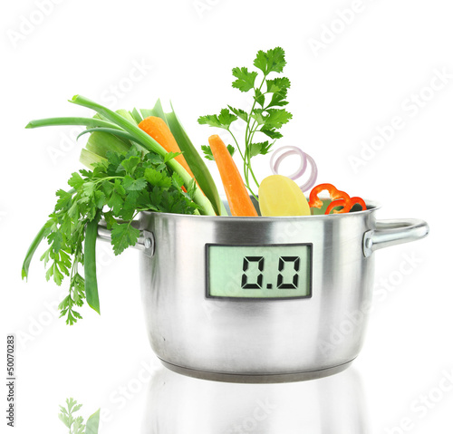 Photo: Fresh vegetables in a casserole pot with digital weight scale Fresh vegetables in a casserole pot with digital weight scale