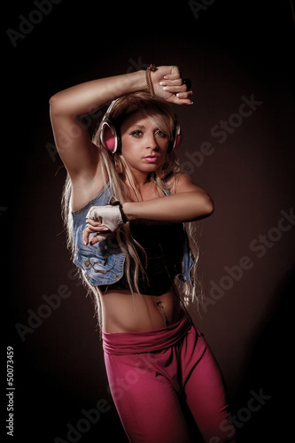 Photo: Sexy blonde woman dancing with headphones Sexy blonde woman dancing with headphones
