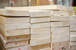 Lumber boards and beams of different sizes lie on racks and pall