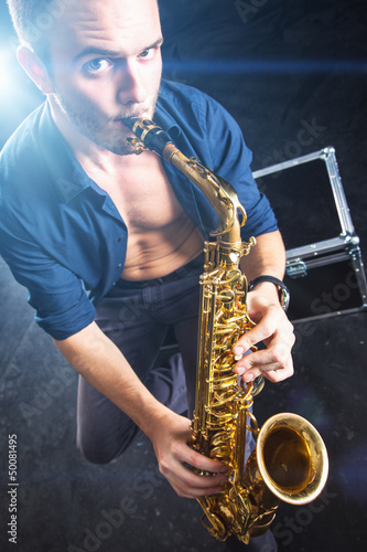Photo: Young man playing the Saxophone. Young man playing the Saxophone.