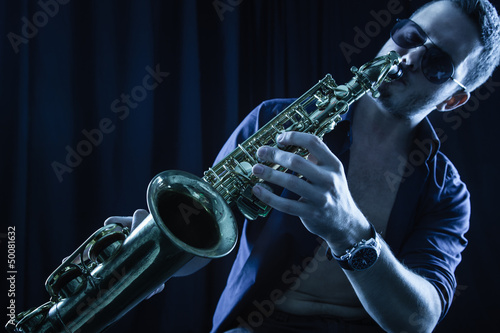 Photo: Young man playing the Saxophone. Young man playing the Saxophone.