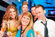 People in club or bar drinking champagne