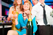 People in club or bar drinking champagne