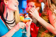 People in club or bar drinking cocktails