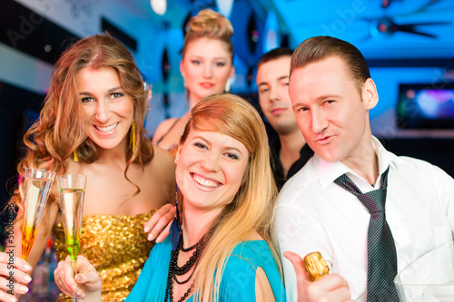 Photo: People in club or bar drinking champagne People in club or bar drinking champagne