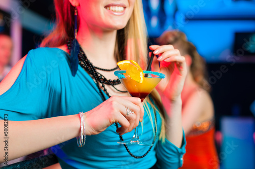 Photo: People in club or bar drinking cocktails People in club or bar drinking cocktails