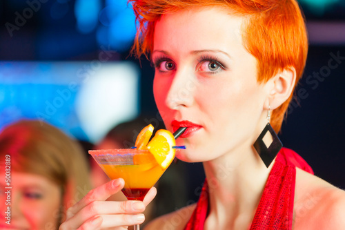 Photo: People in club or bar drinking cocktails People in club or bar drinking cocktails