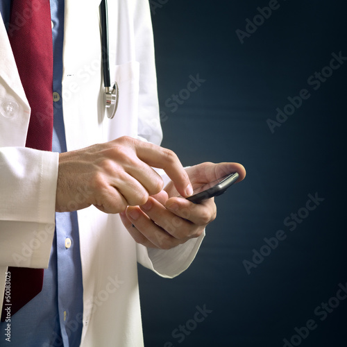 Photo: Doctor using smartphone device Doctor using smartphone device