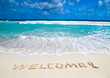 welcome written in beach