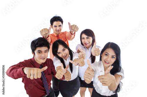 Photo: Business people thumbs up Business people thumbs up